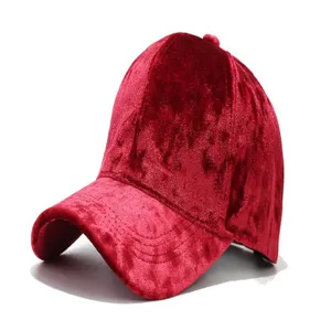 Red velvet baseball cap detail showing soft fabric texture and curved brim design for casual wear.