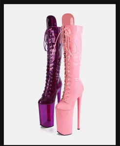Detailed view of glossy patent leather platform knee-high lace-up stiletto boots in pink and purple.