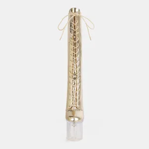 Close-up detail of the gold metallic lace-up knee-high boot featuring a clear high heel.