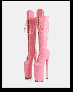 Pink patent leather extreme high heel platform lace up knee high boots close up shot.