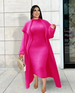Women pink fuzzy dress and long cardigan coat two-piece set, stylish winter outfit.