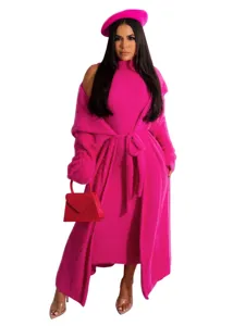 Detail view of the fuzzy knit cardigan and dress set in vibrant pink with matching hat and bag.