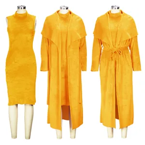 Detailed view of yellow two-piece winter sleeveless dress and long cardigan set on mannequins.