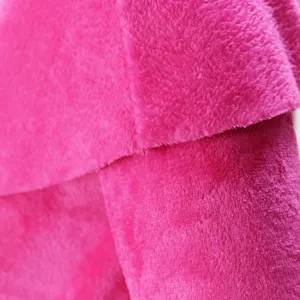 Close-up fabric detail of hot pink plush fleece clothing material, soft texture and cozy feel.
