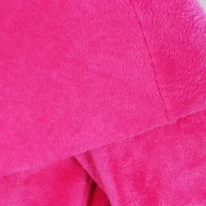 Close-up detail of soft pink plush fleece fabric showing fine texture and neat stitching quality.