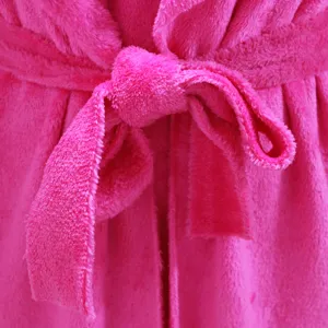 Pink plush fleece bathrobe belt detail close up, soft fluffy loungewear tie texture.