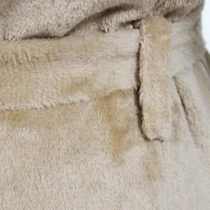 Close-up detail view of plush fleece cardigan belt, soft winter cozy loungewear texture.