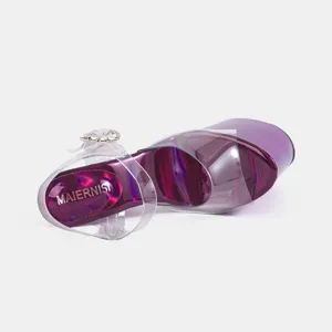 Detail view of purple metallic platform high heels with clear straps and sparkling rhinestones.