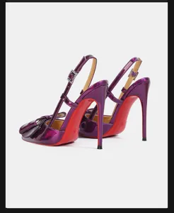 Detailed view of purple patent leather high heel sandals featuring bow and red soles.
