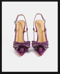 Stunning purple patent leather slingback high heels with bow and iconic red sole design.