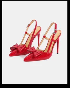 Red patent leather pointed toe slingback high heels featuring chic bow decoration.