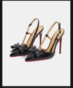Elegant black patent leather slingback high heels featuring chic bow and iconic red sole.