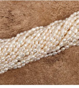 Detail view of 4-4.5mm natural freshwater baroque pearl loose beads with high luster.