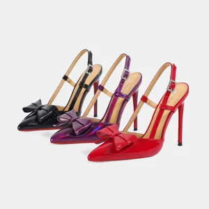 Women's patent leather pointed toe slingback high heels with bow and red sole design.