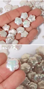 Detailed view of natural baroque pearl flower loose beads in hand, showing high luster and shine.