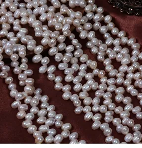 Close-up detail of natural freshwater rice pearl strands, ideal for DIY jewelry making.