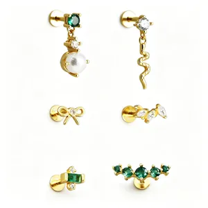 Detailed view of gold-plated S925 silver labret studs with emerald green zircon and pearls.