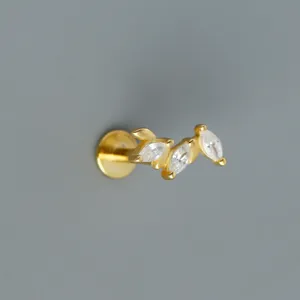 Detailed macro view of a gold-plated S925 sterling silver labret stud with zircon cluster