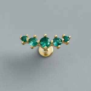 Macro detail of gold plated silver labret earring with five curved green zircons