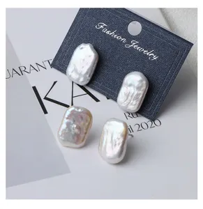 Detail shot of irregular rectangular freshwater pearl stud earrings with vintage 925 silver pins.