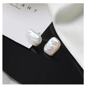 Detailed close-up shot of irregular baroque freshwater pearl stud earrings with sterling silver pins.