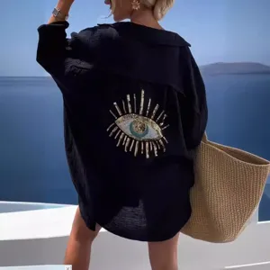 Black oversized long sleeve shirt featuring a striking sequin eye embroidery on back.