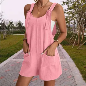 Details of the pink casual summer women's romper showing front pockets and shoulder straps.