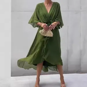 Olive green V-neck dress detail showing waist tie and flowy fabric texture for elegant style.