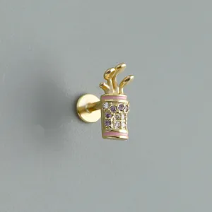Primo piano di un piercing per orecchio in argento s925 dorato a forma di golf con zirconi.