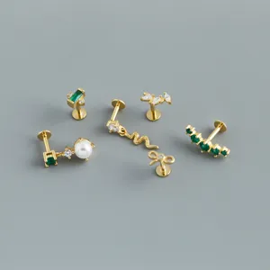 Group of gold-plated S925 silver flat-back labret studs with emerald green stones.