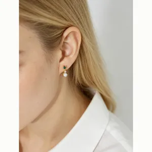 Elegant S925 sterling silver drop earrings with pearl and green gemstone on model