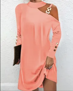 Peach pink asymmetric cutout long sleeve dress featuring stylish gold metal buckle and button cuffs.
