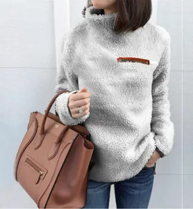 Close-up of cozy grey fleece high-neck pullover sweatshirt featuring a stylish front zipper.