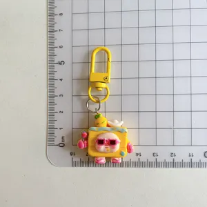 Cartoon character keychain pendant detail view, cute resin bag charm with metal hook.