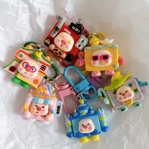 Detailed close-up of cute cartoon piggy character keychains, colorful resin bag charms.