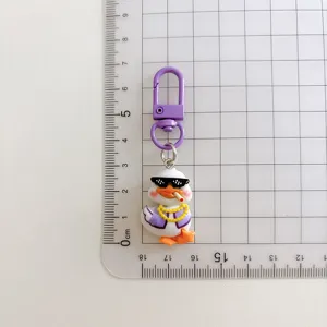 Close-up detail of the cool duck keychain displaying its stylish purple jacket and sunglasses.