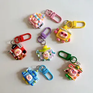 Close-up details of cute cartoon pig keychains in various cosplay outfits with colorful clasps.