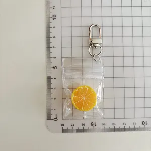 Llavero de rodaja de limón simulada mini bolsa transparente bonito colgante decoración