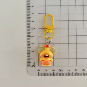 Cute cartoon character keychain pendant with metal hook, perfect bag accessory and gift.