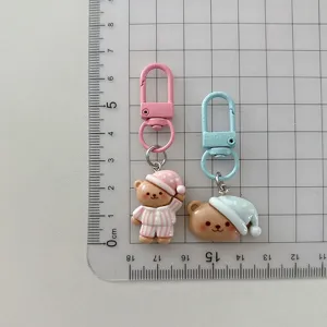 Cute cartoon pajama bear keychain pendant, sweet girl bag charm, and lovely student accessory.