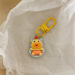 Closeup of a cute cartoon capybara keychain with a yellow metal clasp, lovely bag accessory.