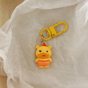 Cute cartoon capybara keychain detail shot, yellow pendant bag accessory for girls and friends.