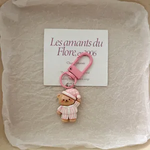 Cute pink pajama bear keychain detail, lovely schoolbag pendant and sweet couple gift accessory.