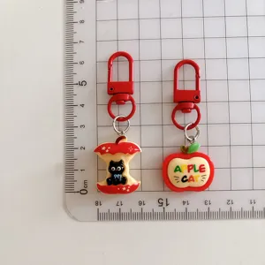 Cute cartoon apple and black cat metal keychain pendant, perfect bag accessory and gift.