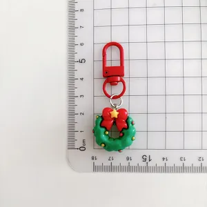 Christmas wreath keychain pendant detail shot showing actual size and cute design features clearly.