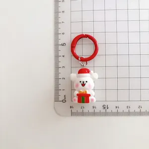 Nahaufnahme eines süßen Cartoon Weihnachten Welpen Schlüsselanhänger mit Größenskala.