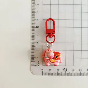 Cute pink cartoon horse keychain with red metal clasp and lucky bag charm for backpacks.