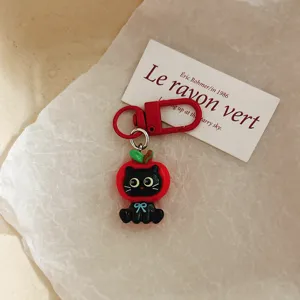 Cute black cat apple keychain detail shot, perfect bag charm and lovely student gift accessory.