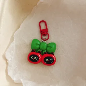 Cute cartoon black cat apple keychain bag charm, creative backpack accessory gift.