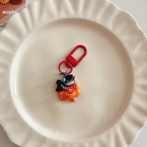Close-up detail of the cute cartoon black cat keychain and bag charm pendant accessory.